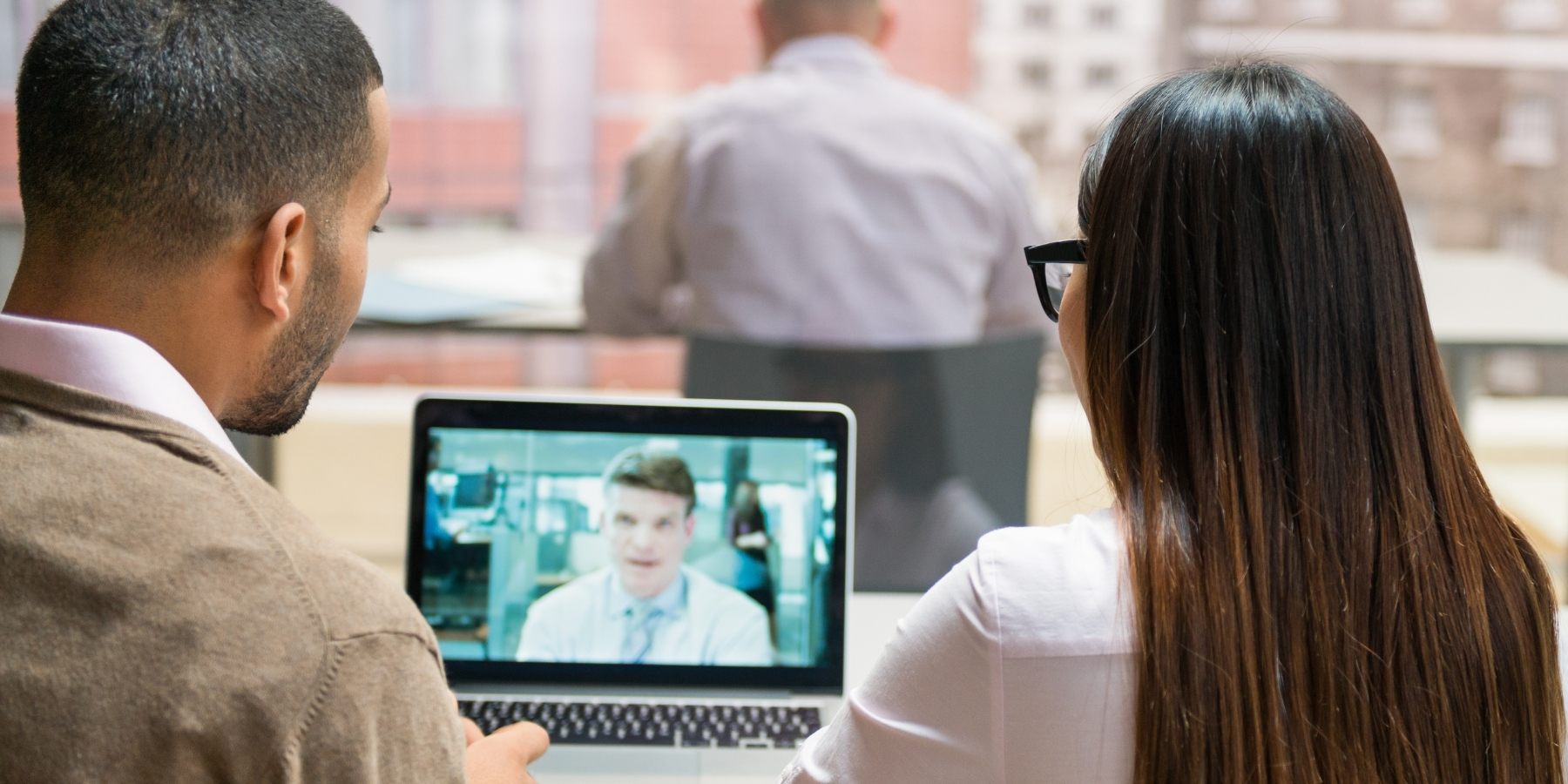 Mobile hybrid environment with two people looking at laptop meeting